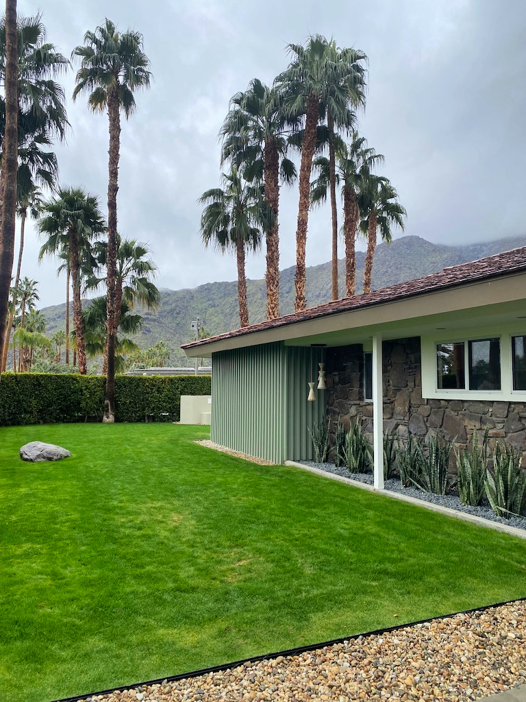 Exterior features natural rock siding, muted green tones, post and beam construction gscinparis