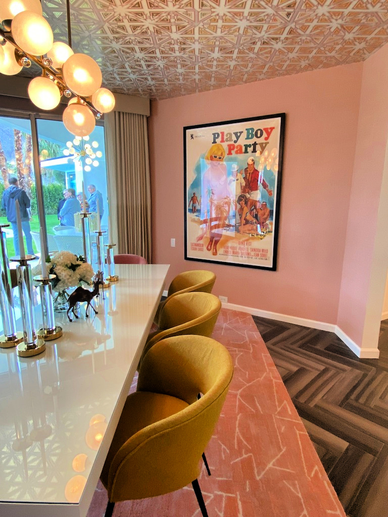 Soft pinks and greens with glowy lighting creates a cozy ambiance in the dining room gscinparis