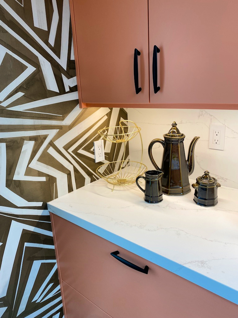 Wallpaper detail in the kitchen and uniquely pink cabinetry gscinparis